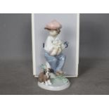 Lladro - A boxed figural group entitled My Best Friend, # 5401, depicting a young boy and a puppy,