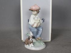 Lladro - A boxed figural group entitled My Best Friend, # 5401, depicting a young boy and a puppy,