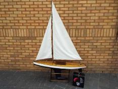 A radio controlled plank built pond yacht.
