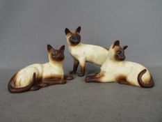 Beswick - Three matte glaze Siamese cat figurines comprising # 1558, # 1559 and similar,
