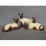 Beswick - Three matte glaze Siamese cat figurines comprising # 1558, # 1559 and similar,