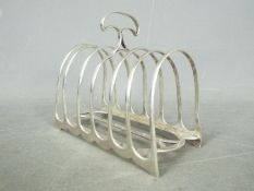 A Victorian, hallmarked silver, six division toast rack, London assay 1890,