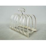 A Victorian, hallmarked silver, six division toast rack, London assay 1890,