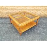 A four panelled, glass topped coffee table,