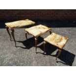 A nest of three brass and onyx tables, largest approximately 43 cm x 53 cm x 33 cm.