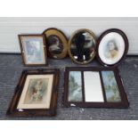A collection of framed prints, portrait of a young child, mirrors.
