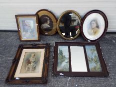 A collection of framed prints, portrait of a young child, mirrors.