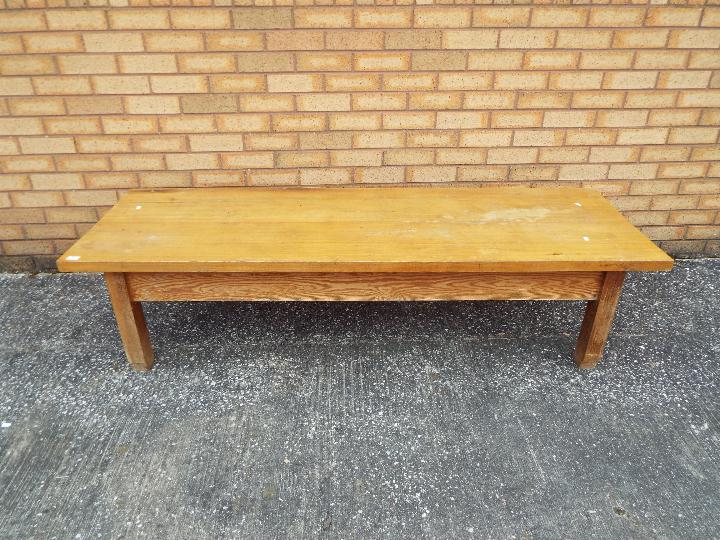 An antique pine coffee table, approximat