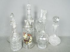 A collection of glass decanters, tallest