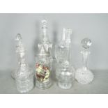 A collection of glass decanters, tallest