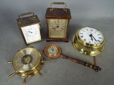 A small collection of clocks and a barom