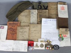 A collection of military items to include a World War Two (WW2 / WWII) defence medal with slip in