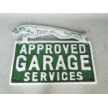 A chrome Jaguar garage services sign,