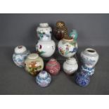 A group of ginger jars, most with covers,