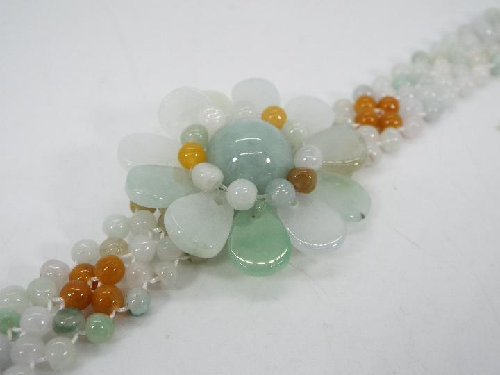 A 121 ct Burmese Natural Jadeite 'Colours of Paradise' flower bracelet set with silver, - Image 2 of 6