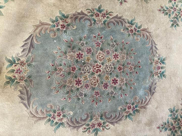 A large rug with floral decoration on a cream ground, approximately 370 cm x 110 cm. - Image 2 of 3