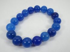 A 237 ct Burmese Blue Jade stretchable bracelet issued in a limited edition 1 of 300,