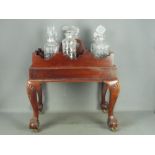 A mahogany stand with carved detailing, on ball and claw,