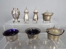 A collection of hallmarked silver cruets, salts and similar, various assay marks,