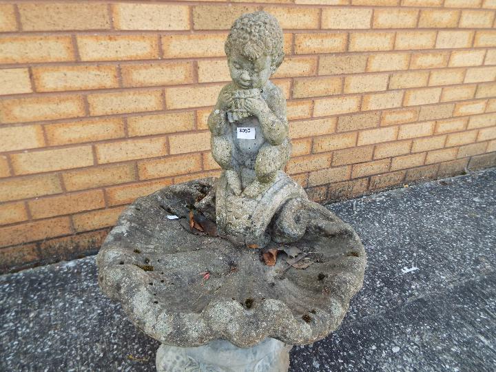 A reconstituted stone bird bath surmounted with pipe playing faun, - Image 2 of 4