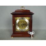 A Comitti of London basket top mantel clock in mahogany case with a Franz Hermle 340-020 movement,