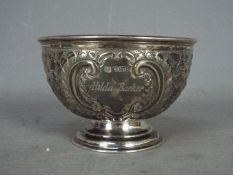 An Edward VII silver footed bowl with repousse decoration, Sheffield assay 1903,