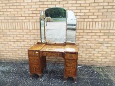 A burr walnut veneered dressing table with triptych mirror, approximately 162 cm x 106 cm x 52 cm.