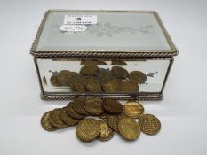 A mirror box of threepence pieces.