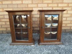 A small pair of cupboards with leaded glass doors, approximately 51 cm x 38 cm x 19 cm.