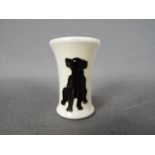 Moorcroft - a Moorcroft black Labrador vase,