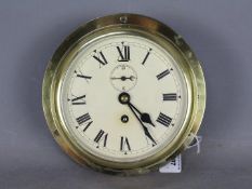 A mid 20th century brass cased ships bulkhead clock, Roman numerals,