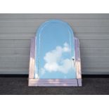 An arch top Art Deco wall mirror with bevelled edge and three peach glass borders,