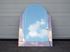 An arch top Art Deco wall mirror with bevelled edge and three peach glass borders,