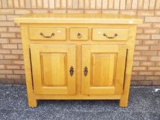 A side unit with three drawers over twin cupboards measuring approximately 102 cm x 124 cm x 51 cm.