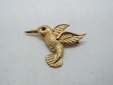 A 9ct yellow gold brooch in the form of a Kingfisher with blue stone set eye,