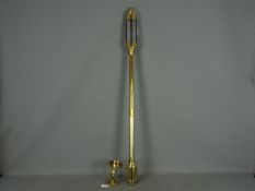 A brass cased marine stick barometer, the silvered dial marked Russell Norwich,