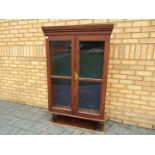 A vintage gun cabinet with twin glazed doors, approximately 147 cm x 93 cm x 28 cm.