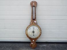 A banjo barometer with inlaid decoration, silvered temperature and barometric dials,