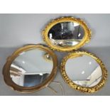 Three decorative wall mirrors, largest approximately 47 cm (d).