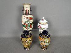 An Oriental ceramic group comprising a Nanking vase decorated with warriors,