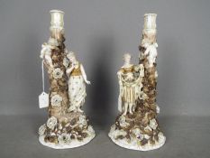 A pair of continental porcelain figural candlesticks, approximately 37 cm (h).