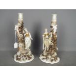 A pair of continental porcelain figural candlesticks, approximately 37 cm (h).