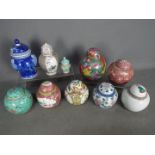A collection of ginger jars and covers,