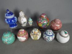 A collection of ginger jars and covers,