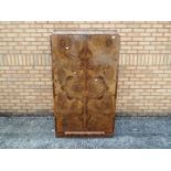A burr walnut veneered wardrobe of small scale, twin doors with fitted interior,