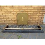 A brass and cast iron fire fender with black painted base,