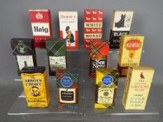 Twelve whisky miniatures in card sleeves comprising Famous Grouse 70° proof, Old Mull 70° proof,