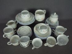 A quantity of tea wares comprising Royal Doulton Expressions Summer Carnival and Queen's Claire.