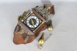 A Zaanse type wall clock, brass and wood, with two pear shaped weights.