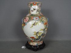 A large vase decorated with panels of birds against a millefiori ground,